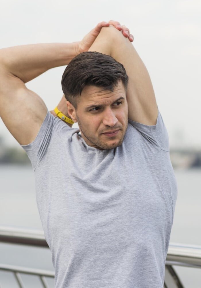 portrait-adult-male-stretching-outdoors